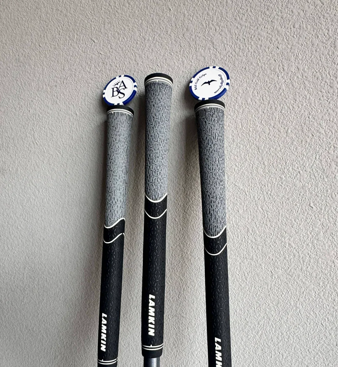Three finished black and gray Lamkin golf grips
