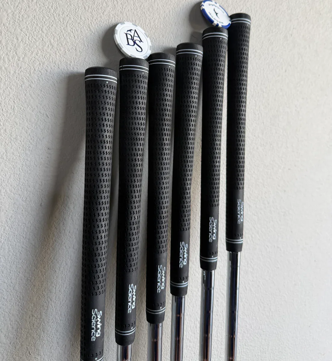 Finished golf clubs fitted with black Swing Science grips