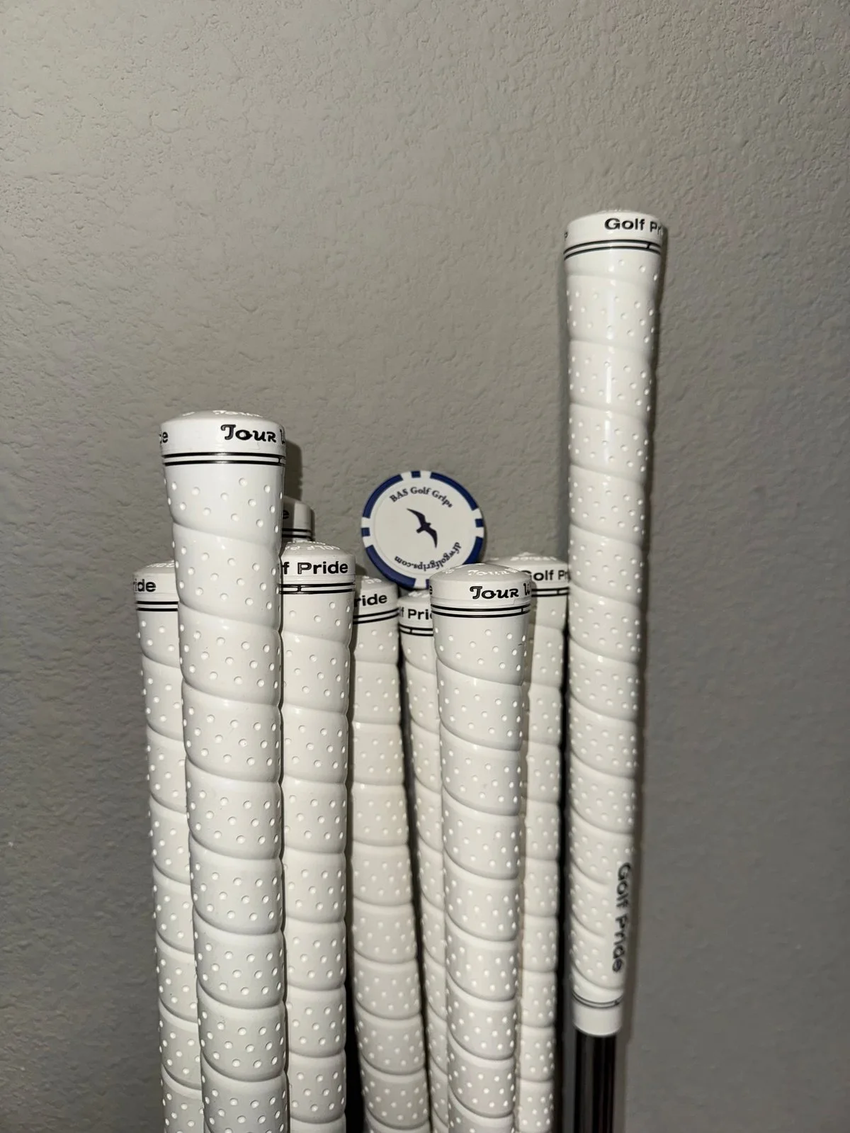 Completed white wrap-style grips installed on a golf club set