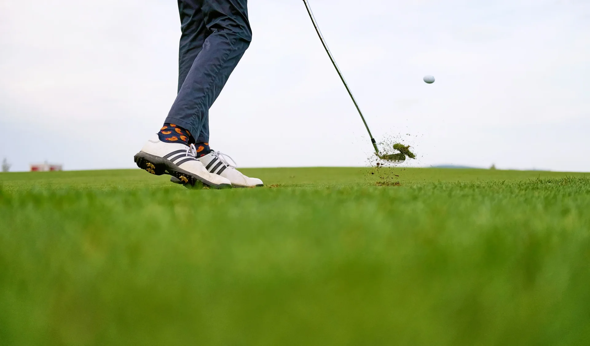 Golfer striking an iron shot from the fairway