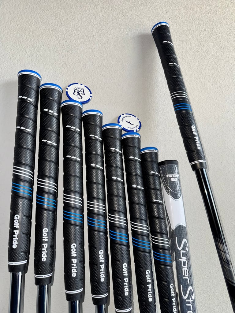 Collection of golf club grips in black with blue and white stripes, arranged in ascending size order