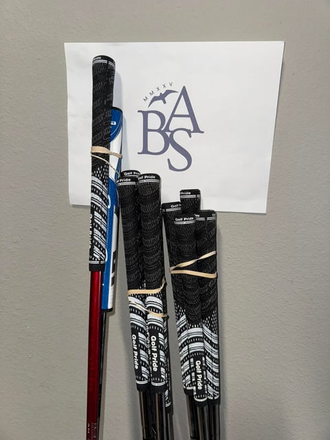 Collection of baseball bats with black textured grips with BABS logo